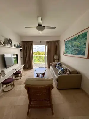 a living room with a couch and a table at PentHouse Jakuzzi Hotel Hard Rock in Punta Cana