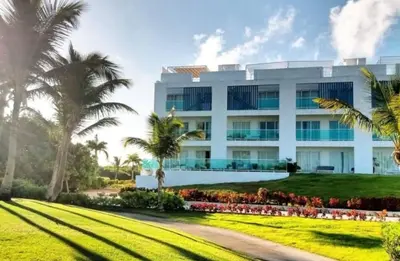 a white building with palm trees in front of it at PentHouse Jakuzzi Hotel Hard Rock in Punta Cana