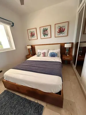 a bedroom with a large bed with two lamps and a window at PentHouse Jakuzzi Hotel Hard Rock in Punta Cana