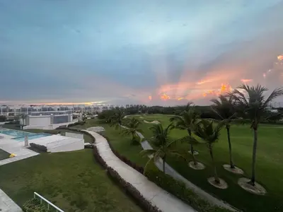 a rainbow in the sky over a resort with palm trees at PentHouse Jakuzzi Hotel Hard Rock in Punta Cana