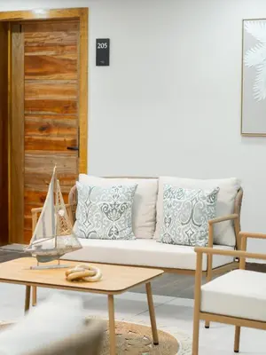 a living room with a couch and a table at Ocean Winds Hotel in San Felipe de Puerto Plata