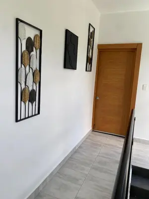 a hallway with a wooden door and a staircase at Villa Tula in Sosúa