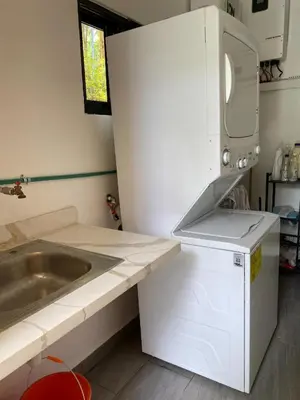 a small kitchen with a sink and a microwave at Villa Tula in Sosúa