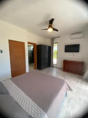 a bedroom with a bed and a ceiling fan at Villa Tula in Sosúa