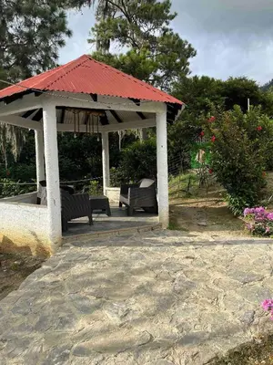 a gazebo with a red roof and two benches at Nice mountain cabin, with the best view