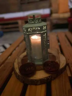 a candle in a glass container on a wooden table at Nice mountain cabin, with the best view