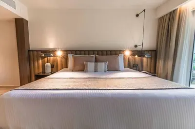 a bedroom with a large white bed with two pillows at Family Selection at Grand Palladium Select Bávaro - All Inclusive in Punta Cana