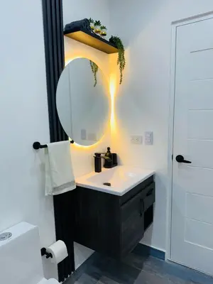 a bathroom with a sink and a mirror at Residencial mar azul Bayahibe in Bayahibe