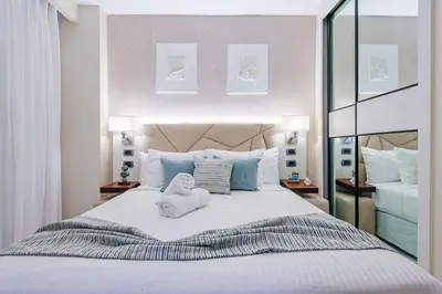 a bedroom with a large bed with towels on it at Comfy Retreat Balcony Grill Pool in Punta Cana