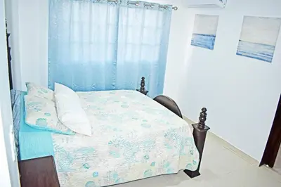 a bedroom with a bed and a window at Best location Big 3 Bdrs, Fully Stocked and A/C in Santo Domingo