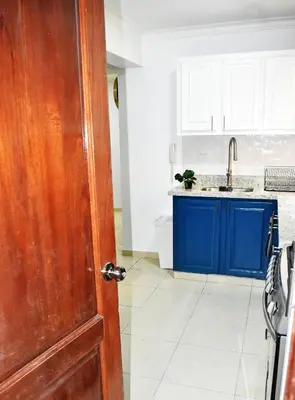 an open door to a kitchen with blue cabinets at Best location Big 3 Bdrs, Fully Stocked and A/C in Santo Domingo
