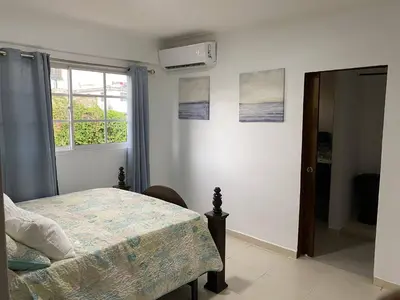 a bedroom with a bed and a window at Best location Big 3 Bdrs, Fully Stocked and A/C in Santo Domingo