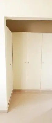 a room with white cabinets and a white wall at Apartamento en Residencial Los Pinos Cotui in Cotuí