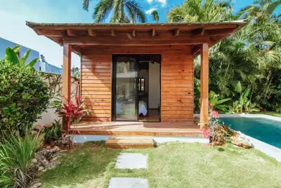a small cabin with a deck next to a pool at Tropical Bliss Retreat in Las Terrenas