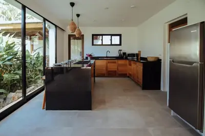 a large kitchen with a stainless steel refrigerator at Tropical Bliss Retreat in Las Terrenas