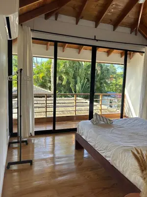 a bedroom with a bed and a large window at Tropical Bliss Retreat in Las Terrenas