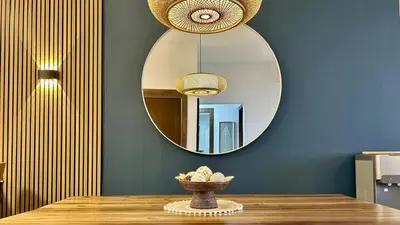 a table with a mirror on a blue wall at ALL-NEW Modern and Stylish Apartment with Rooftop Infinity Pool in Las Terrenas
