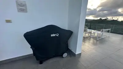 a black trash can sitting on a balcony at ALL-NEW Modern and Stylish Apartment with Rooftop Infinity Pool in Las Terrenas