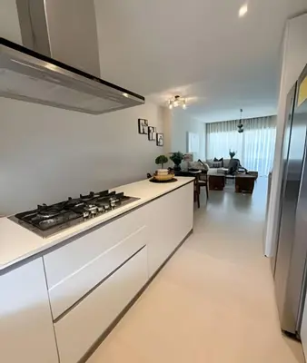 a kitchen with white cabinets and a stove top oven at Gardenia B31 in Punta Cana