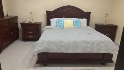 a bedroom with a large bed with two night stands at Manuel