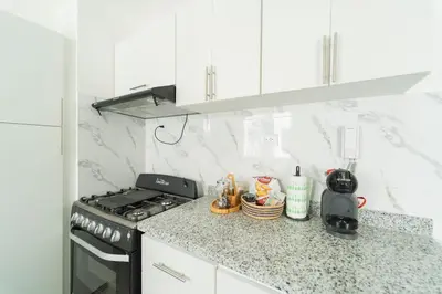 a kitchen with a stove and a counter top at SoliMar Caribeño in Boca Chica