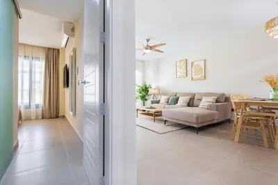 a living room with a couch and a table at Brand New 2BR Stylish Apartment in the Heart of Punta Cana, Gardenia Gated Community in Punta Cana