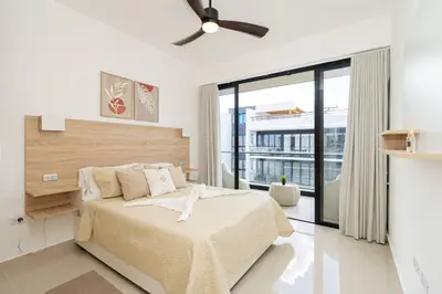 a bedroom with a bed and a ceiling fan at Spacious 3BD Penthouse Private Rooftop Sea Breeze - Oasis in San Rafael del Yuma
