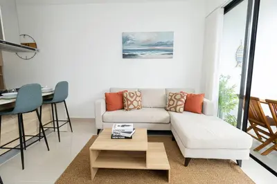 a living room with a couch and a table at Spacious 3BD Penthouse Private Rooftop Sea Breeze - Oasis in San Rafael del Yuma