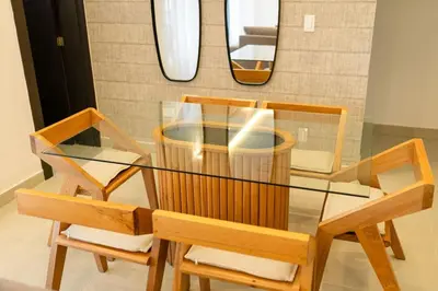 a glass table with two chairs and a mirror at Views, pool and gym, 2 BR family friendly in Santiago de los Caballeros