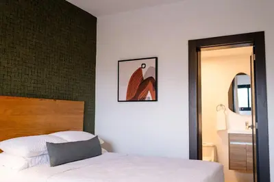 a bedroom with a bed and a picture on the wall at Views, pool and gym, 2 BR family friendly in Santiago de los Caballeros
