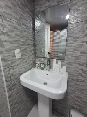 a bathroom with a white sink and a mirror at Beautiful condo in Sosua walking distance from everything in Sosúa