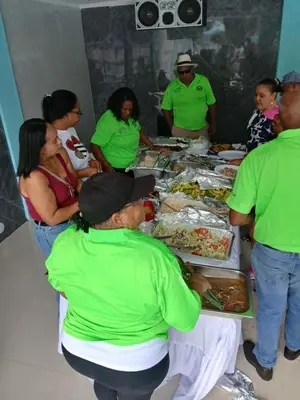 a group of people standing around a table full of food at Paraíso Vacacional FERNANDO in Polo