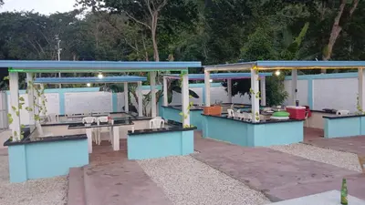 a blue building with tables and chairs in a yard at Paraíso Vacacional FERNANDO in Polo