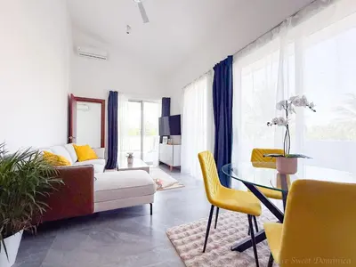 a living room with a couch and a table at Elysium Suits Maximum Comfort in Punta Cana