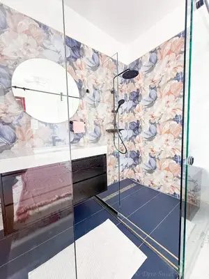 a bathroom with a shower with a glass wall at Elysium Suits Maximum Comfort in Punta Cana