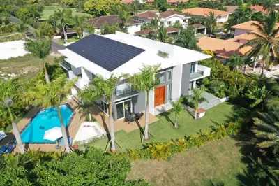 an aerial view of a house with a solar roof at Elysium Suits Maximum Comfort in Punta Cana