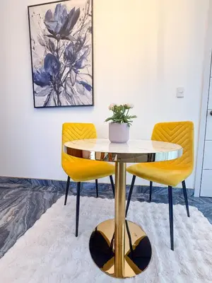 a table and two chairs in a room at Elysium Suits Maximum Comfort in Punta Cana