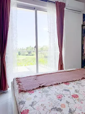 a bedroom with a bed and a large window at Elysium Suits Maximum Comfort in Punta Cana
