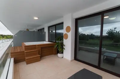 a balcony of a house with a large window at Cana Rock Star D208 Jaccuzi Pool Golf and Private Beach in Punta Cana