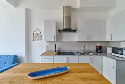 a kitchen with a wooden table with a blue object on it at Juan Dolio RD Beach Retreat in Juan Dolio