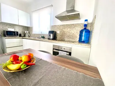 a bowl of fruit on a table in a kitchen at Los corales 1Bedroom Apartament Close to the Beach Central los corales RD in Punta Cana