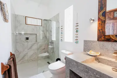 a bathroom with a shower and a toilet and a sink at Bali Style Boutique Hotel in Las Terrenas
