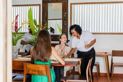 a man and two women sitting at a table at Bali Style Boutique Hotel in Las Terrenas