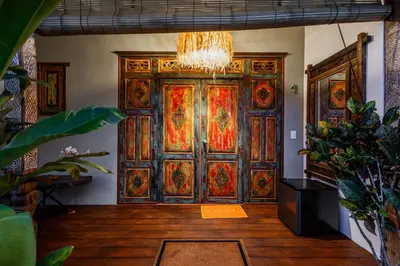 a large wooden door with colorful stained glass at Bali Style Boutique Hotel in Las Terrenas