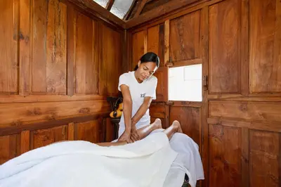 a woman sitting on top of a bed at Bali Style Boutique Hotel in Las Terrenas