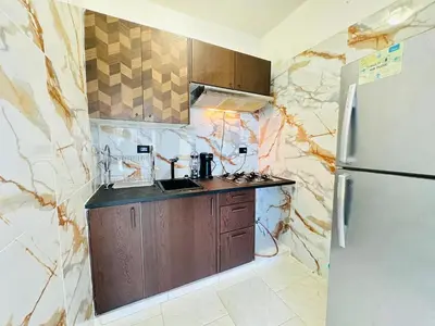 a small kitchen with a refrigerator and a sink at Apartartamento cabarete in Cabarete