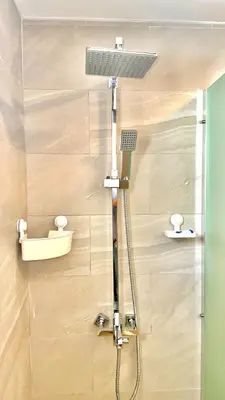 a shower with a shower head in a bathroom at Rheia Properties - SANTA FE in Sosúa
