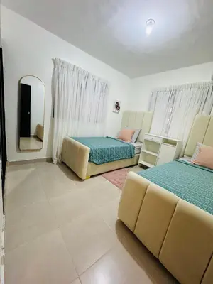 a living room with two beds and a mirror at Luxurious and comfortable 1 level in Juan López