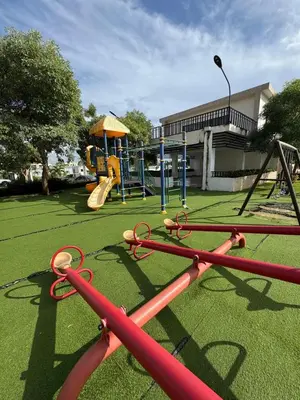 a playground with a slide and a swing at Luxurious and comfortable 1 level in Juan López
