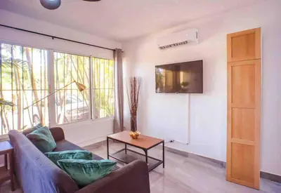 a living room with a couch and a table at nNomad Apartment steps to Sirena - Apartment in Sosúa